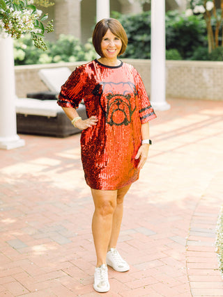 a red and black sequin uga bulldog dress with short sleeves perfect for game day and tailgating shown with white sneakers