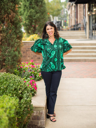 an emerald and black short sleeve blouse with dramatic puff sleeves for moody fall and winter fashion shown with black pants