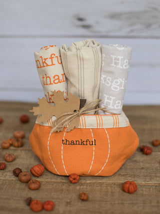 a collection of canvas hand towels with thanksgiving patterns in a pumpkin holder perfect for fall decor gifts