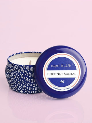 a blue miniature tin candle with scents of hibiscus lime coconut and amber