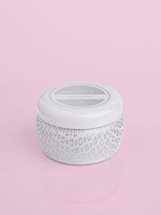 a small white tin tropical punch scented candle