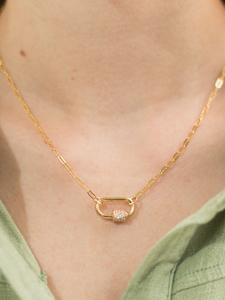 a gold locket necklace with rhinestone details