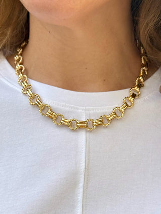 a shiny gold twisted link chain necklace with double connectors
