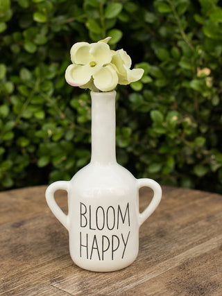 a mottled ceramic white bud vase with creamy glaze and debossed sentiment that reads bloom happy