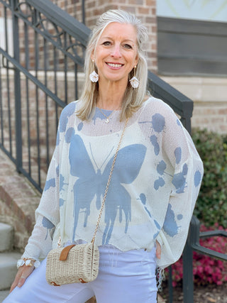 vibrant white and blue butterfly splatter print oversized sweater top with frayed ends