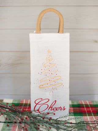 a white and red christmas wine tote with a gold embroidered tree perfect for holiday home decor and as host gifts