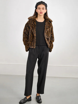 a soft faux fur cheetah print jacket with a large collar worn over a black top and black pants