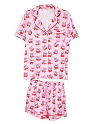 pink pajama set with short sleeve button up top with cherries and bows print and draw string shorts