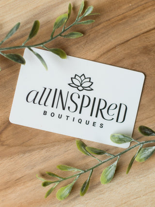 a white all inspired gift card with logo and text in black