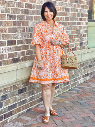 flowy two tone orange pattern collared mini dress with balloon sleeves worn with brown sandals
