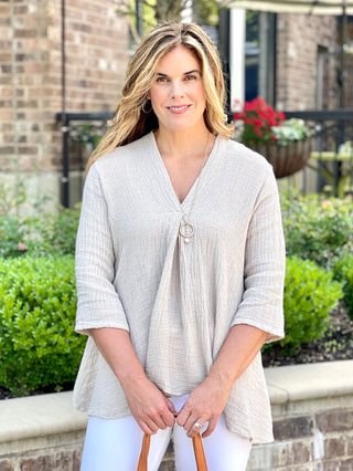 flattering cobblestone sand linen top with three quarter sleeves and relaxed fit