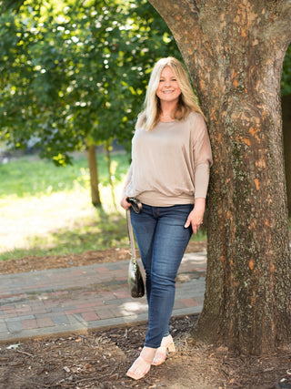 a taupe italian silk blouse with semi sheer three quarter sleeves perfect for luxury everyday dressing shown with denim
