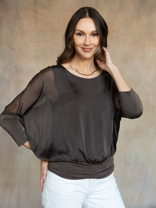 a soft sheer and flowy espresso brown three quarter sleeve blouse overlaying a solid tank