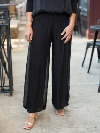 a pair of luxury black italian silk wide leg pants in a flowy fit perfect for everyday chic fall fashion