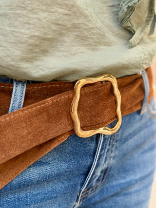 brown suede belt with a gold buckle