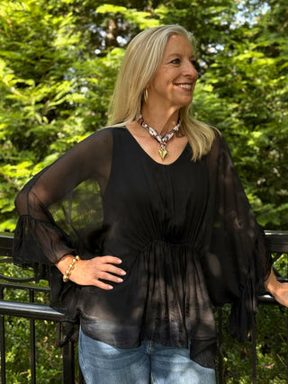 black top with sheer sleeves and cinched waist