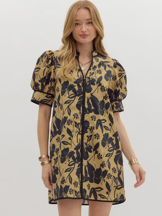 a camel brown and black floral mini dress with short puff sleeves and a split neck