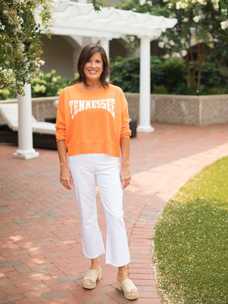 an orange sweatshirt with white lettering that reads tennessee perfect for vols football game days shown with white pants
