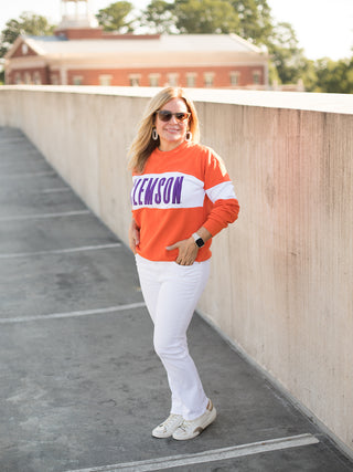 a clemson sweatshirt with orange and white color block perfect for fall football games and tiger pride shown with white pants