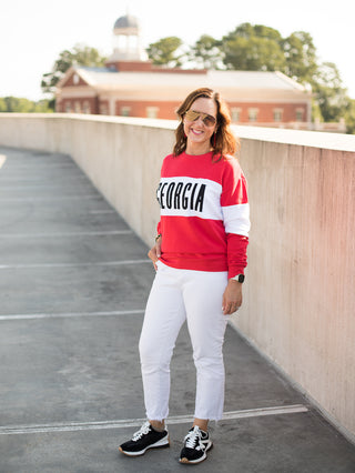 a uga bulldogs sweatshirt with red and white color block perfect for georgia dawgs pride shown with white pants