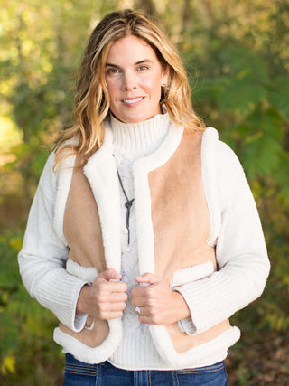 wear this white and tan sherpa vest in faux suede to holiday and christmas gatherings for a chic winter look 
