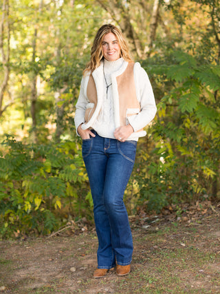 wear this white and tan sherpa vest in faux suede to holiday and christmas gatherings for a chic winter look with denim