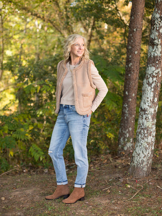 wear this tan sherpa vest in faux suede to holiday and christmas gatherings for a chic winter look with brown boots