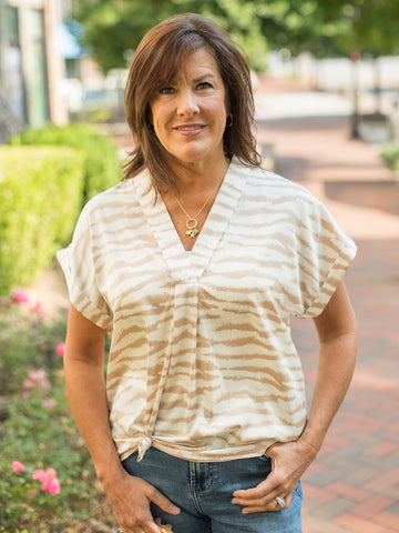 a v neck cap sleeve blouse in latte colored zebra print
