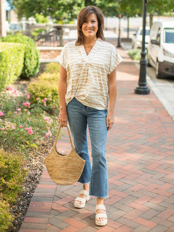 a v neck cap sleeve blouse in latte colored zebra print paired with denim pants