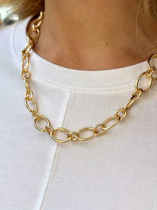 a simple chunky gold oval linked necklace made for charms