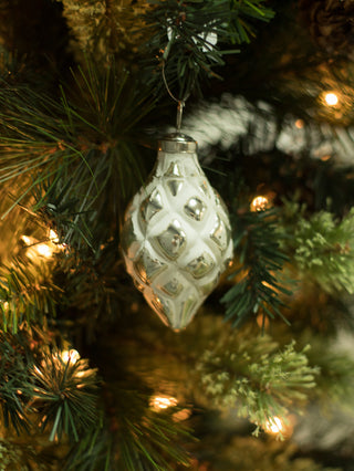 a vintage inspired modern christmas tree ornament in silver and white perfect as holiday host gifts
