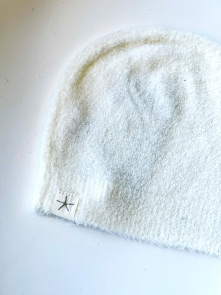 soft barefoot dream baby beanie in light white color