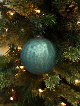 a textured blue green christmas tree ornament made from mercury glass perfect as a holiday hostess gift