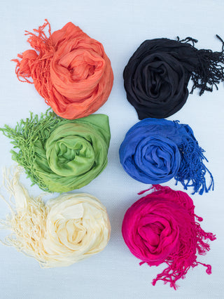 a collection of crinkle scarves in a wide variety of colors featuring the black scarf