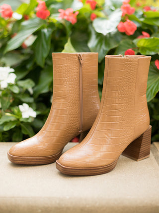 a pair of camel colored ankle boots with a comfort block heel and subtle snakeskin texture great for fall footwear