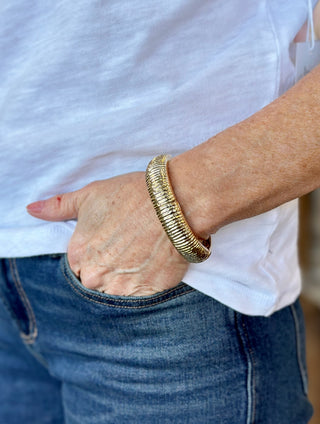 a chunky gold ribbed stretch bracelet
