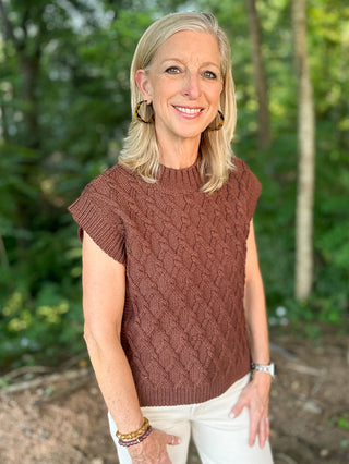 a brown cable knit sweater vest with short sleeves made to wear alone or layer in the fall and winter