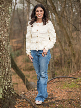 long sleeve cream colored lady jacket with gold brass buttons shown with denim pants