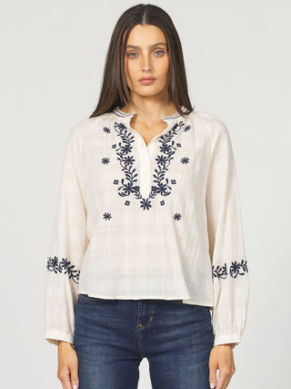 white blouse with navy blue embroidery half button up and long sleeves