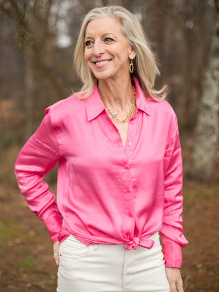 hot pink button down silk blouse with long sleeves and tie waist