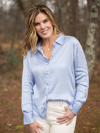 pale blue button down silk blouse with long sleeves and tie waist