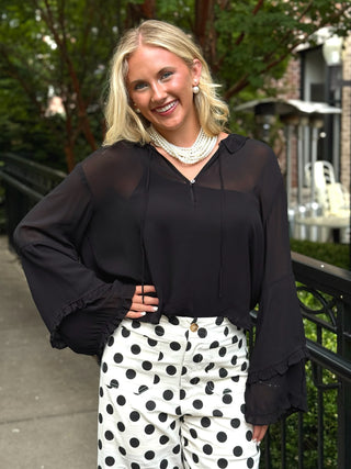black sheer flowy blouse with long ruffle sleeves and v neck with front tie 