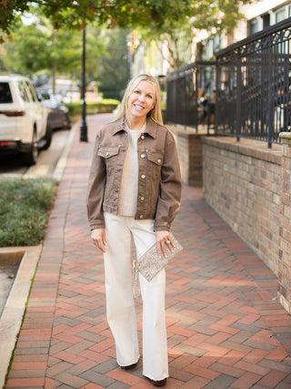 a light brown shacket with silver buttons and a relaxed silhouette perfect for fall fashion layering shown with white pants