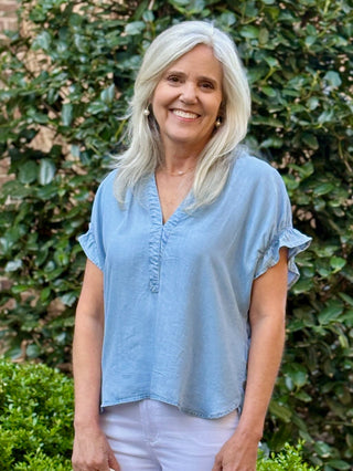 light blue flattering v neck top with back cinched detailing
