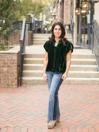 wear this emerald green velvet top with puff sleeves to christmas holiday parties as a feminine winter outfit with denim