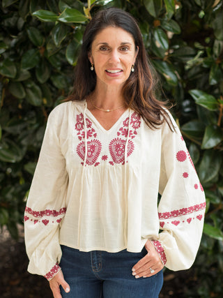 a boho chic blouse with red embroidery on the cream long sleeve top perfect for summer to fall fashion