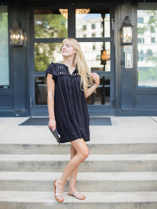 a little black dress with embroidery and a relaxed fit for summer to fall looks shown with ivory sandals