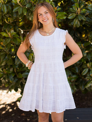 a sleeveless woven white dress with ruffles and a tiered skirt in a relaxed fit