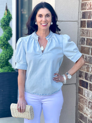 light blue shirred puff sleeve top with ruffled v neck