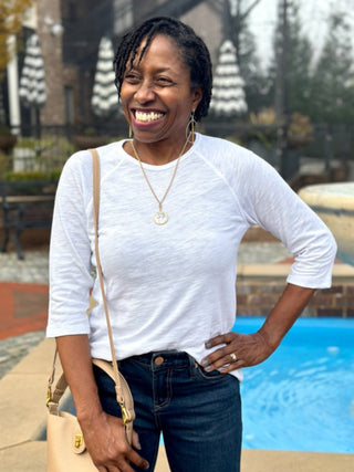 a basic white crew neck shirt with three quarter sleeves